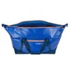 The sustainable migrate duffel bag by Eagle Creek, shown here in mesa blue, is a 90 liter duffel bag with blue fabric, orange zippers, and navy straps that is made from durable and weather-resistant recycled materials.