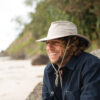 Man on beach in crushable, recycled boating and travel hat in khaki