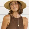 Woman in organic raffia crushable travel hat