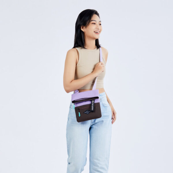 The earth-friendly Sherpani Pica crossbody bag, shown here in Lavender and brown colorblock with turquoise zipper pulls, is sustainably-made and has 5 pockets for all your gear.