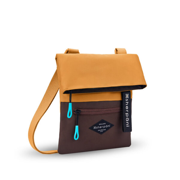 The sustainably-made Sherpani Pica crossbody bag is shown here in Sundial, which is a color-blocked mustard and brown bag with bright turqoise zipper pulls.