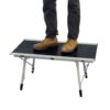 Man standing on lowest height of adjustable-heigh Grand Canyon outdoor travel table