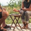 People playing game on foldable, bamboo outdoor side table for sustainable travel