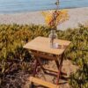 View of foldable bamboo side table outdoors on beach