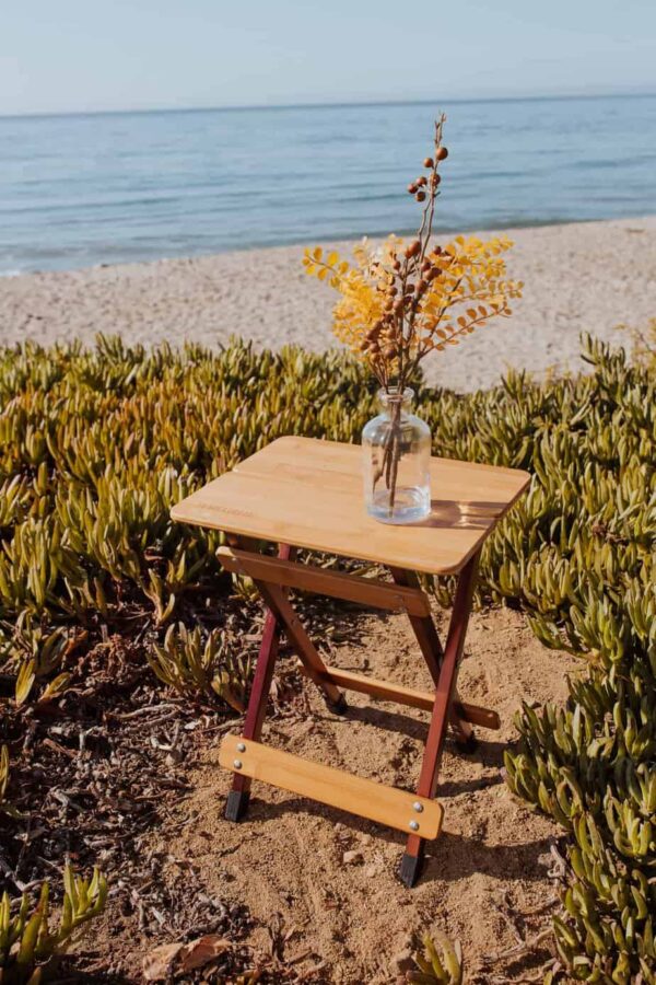 View of foldable bamboo side table outdoors on beach