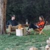 Couple outdoors with set of portable, hand-crafted wood furniture