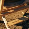 Close up view of Made-In-USA stamp on wood, portable chair on beach