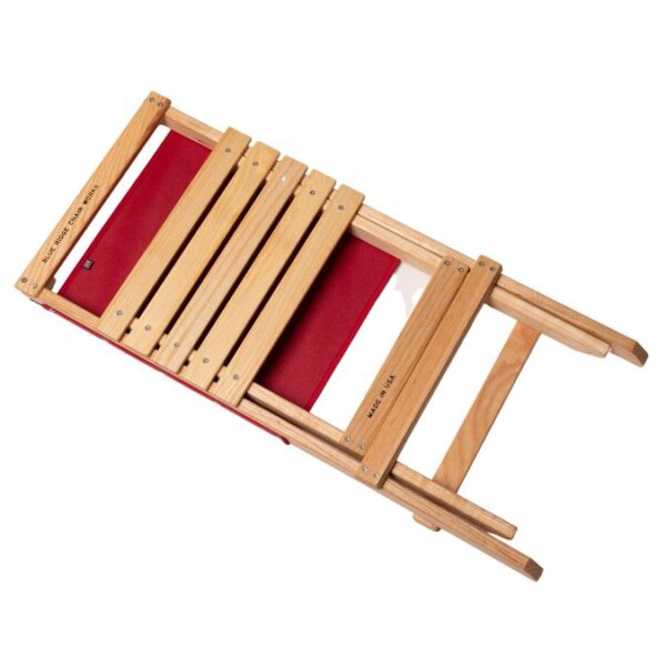 Flat folded view of wood, foldable travel chair with red back