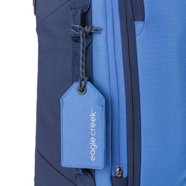 View of recycled blue luggage tag on suitcase for travel