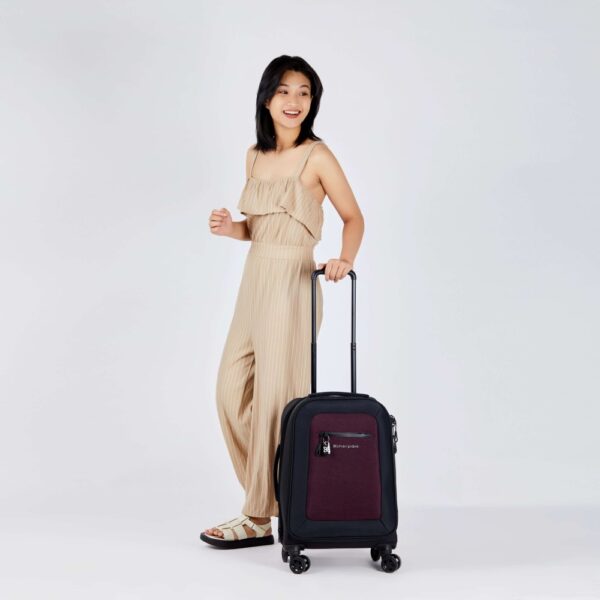 The eco-friendly Latitude rolling luggage by Sherpani is carry-on friendly and made with recycled materials. Shown here in merlot red.