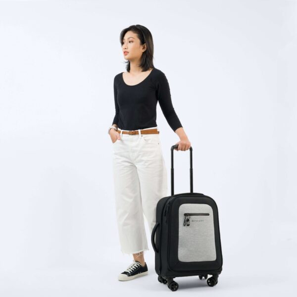 The earth-friendly Latitude rolling luggage by Sherpani is carry-on friendly and made with recycled materials. Shown here standing on 4 sturdy wheels in sterling gray.