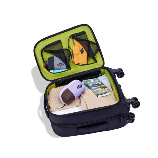 The eco-friendly Latitude rolling luggage by Sherpani is carry-on friendly and made with recycled materials. The lime green interior is shown here with zippered pockets and a roomy main packing space.
