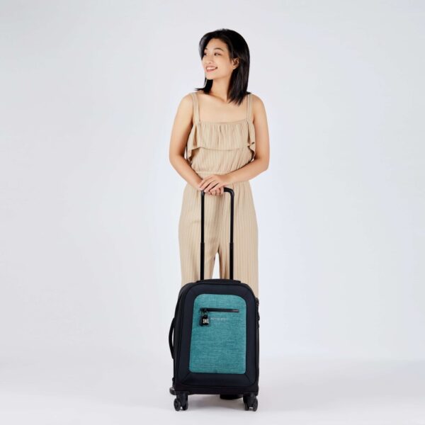 The Latitude rolling luggage by Sherpani is carry-on friendly and made with recycled materials. Shown here with 4 sturdy wheels and extendable handle in teal.