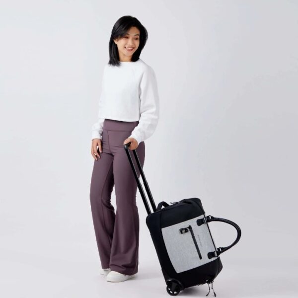 The Trip rolling duffel bag, shown here in sterling gray and black, is water resistant. The bag is made of recycled fabrics and can be carried as a duffel or a roller bag.