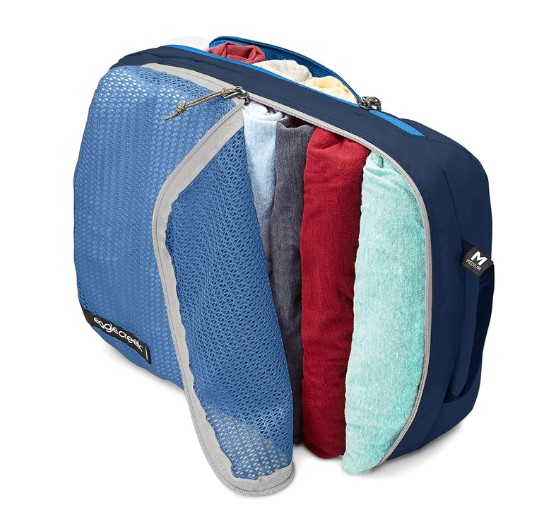 Side view of travel clothes in dual pocket packing cube made from recycled materials