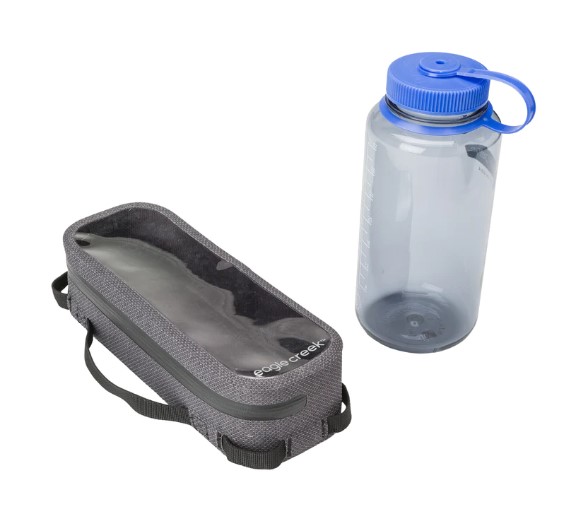 View of slim size waterproof pouch for camping or travel next to water bottle