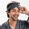 Man wearing sustainable travel eye mask