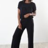 Model is wearing sustainable power pants in black by JJWINKS. This is a carbon neutral product made in the USA.