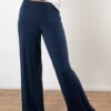 Model is wearing sustainable power pants in navy by JJWINKS. This is a carbon neutral product made in the USA.