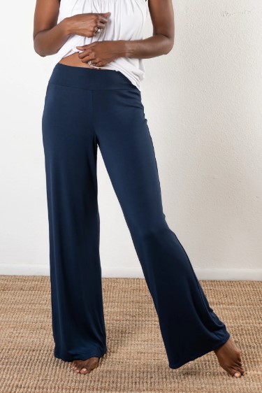 Model is wearing sustainable power pants in navy by JJWINKS. This is a carbon neutral product made in the USA.
