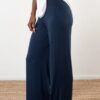 Model is wearing power pants in navy by JJWINKS. This is a carbon neutral product made in the USA.
