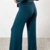 Model is wearing sustainable power pants in teal by JJWINKS. This is a carbon neutral product made in the USA.