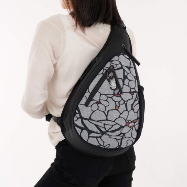 The Esprit AT Shoulder Sling Bag is shown here with someone wearing the Sakura pattern.