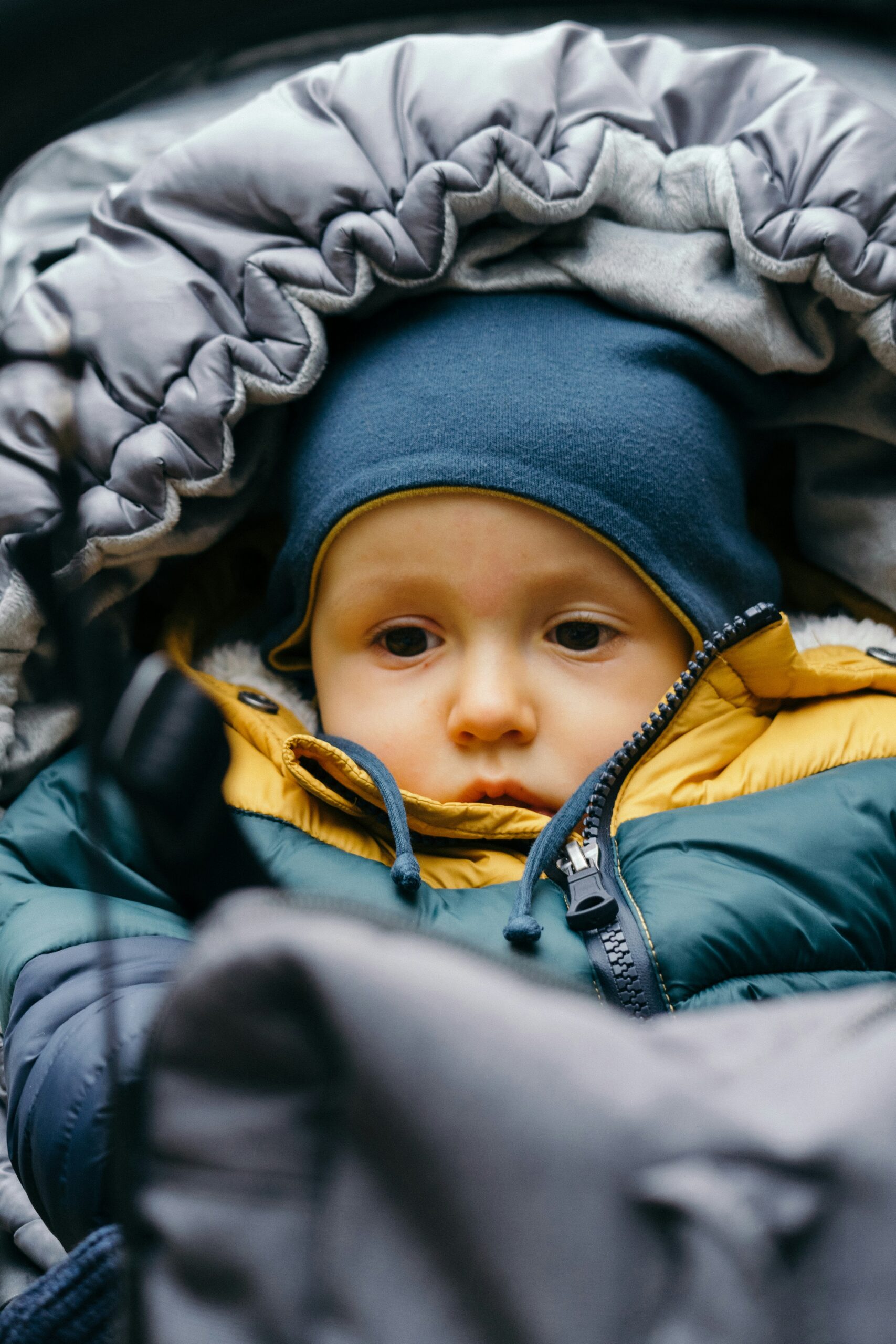 This picture shows a baby bundled up in warm clothes for a blog on cutting down on heating bills this winter.