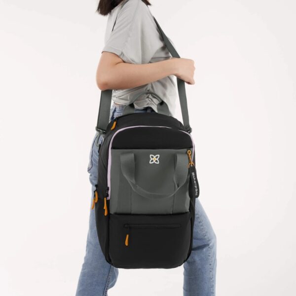 This image shows someone wearing the Camden Convertible Backpack hanging over their shoulder, like you would wear a purse. This would be another way to use the crossbody strap, if you don't want the bag across your body. This is a detachable strap. It can also adjust in length anywhere from 24-48 inches.