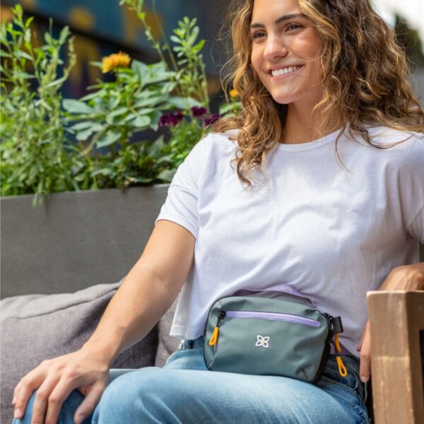 This picture shows someone sitting down with the Sherpani Hyk Hip Pack around their waist. It demonstrates how you can still sit comfortably even with the bag still belted around you.