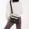 This shows someone wearing the Pica Mini Crossbody Bag slung across their body with the bag hanging on their backside.