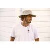 This shows a man wearing the Aussie Surf Organic Cotton hat. It comes in one color, khaki. It's offered in 5 sizes: small, medium, large, x-large, xx-large. The wide brim offers great sun protection. The hat can get wet and dry naturally. It packs flat for travel.