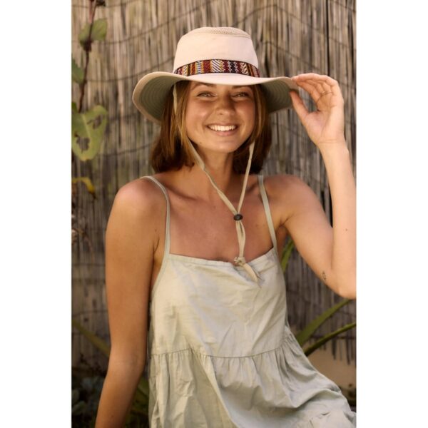 This shows a woman wearing the sand colored Aztec Boater Recycled hat. It's made from 100% recycled bottles. It even floats! There's a chin cord with a secure toggle, as well as an inside secret pocket and ventilation. It comes in one color and 5 sizes: small, medium, large, x-large, xx-large.