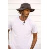 This shows a man wearing the Dusty Road Aussie Waterproof Cotton Hat. It comes in one color, brown. It offers 50+ UPF protection. It's made with weathered cotton and comes in 5 sizes: small, medium, large, x-large, xx-large.